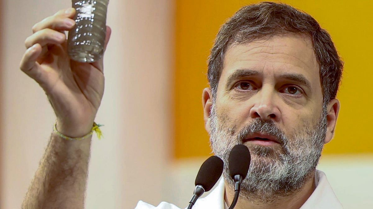 Rahul Gandhi holds up a bottle of water supplied in the national capital (photo: PTI: PTI)