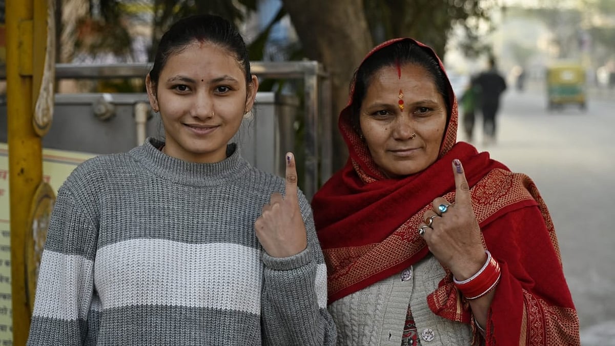 Voters pose after casting their vote a a polling station in Delhi on 5 February 2025 (photo: Vipin/NH)