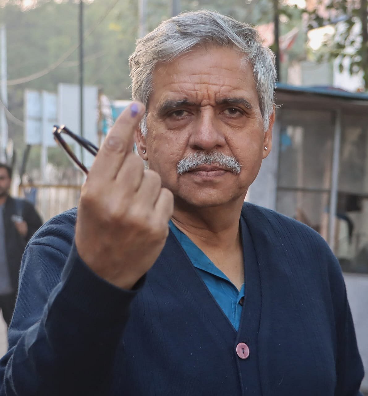 Sandeep Dikshit of the Congress holds up his inked finger (photo: Vipin/NH)