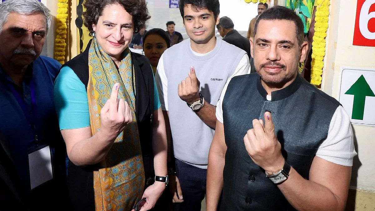 Priyanka Gandhi Vadra shows off her inked finger, with Robert Vadra (right) and son Raihan (centre) 