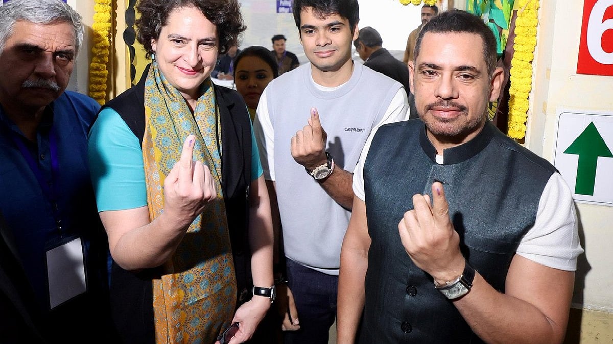 Priyanka Gandhi Vadra shows off her inked finger, with Robert Vadra (right) and son Raihan (centre)