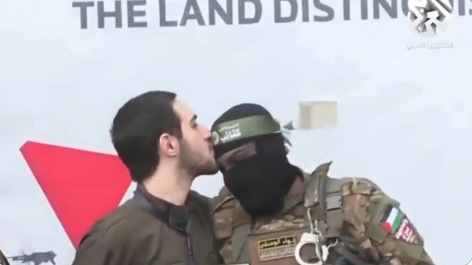 An Israeli soldier kisses the head of a Hamas fighters before his release, 22 Feb. 2025