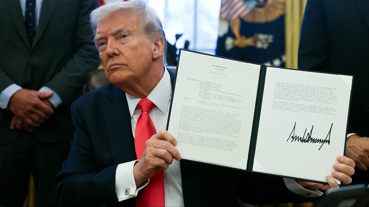 Donald Trump holds a memorandum at White House on 25 February (photo: PTI)