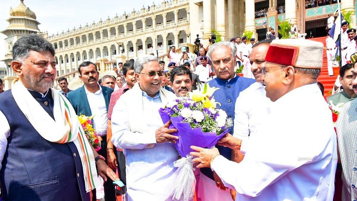 Karnataka CM Siddaramaiah (centre) greets governor T.C. Gehlot (R) with deputy CM D.K. Shivakumar (L)