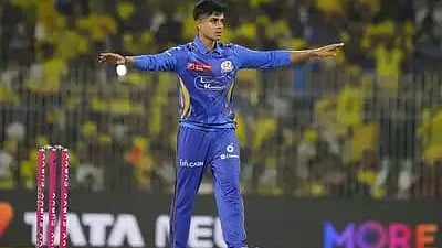 Vignesh Puthur celebrates one of his wickets on 23 March (photo: BCCI)