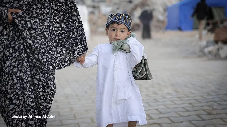 A child dressed up for Eid prayers in Gaza—with perhaps a longer journey ahead as IDF orders evacuations