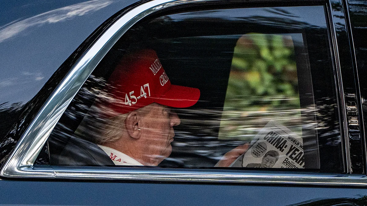Donald Trump reads arrives at Trump National Golf Club on 5 April (photo: AP/PTI)