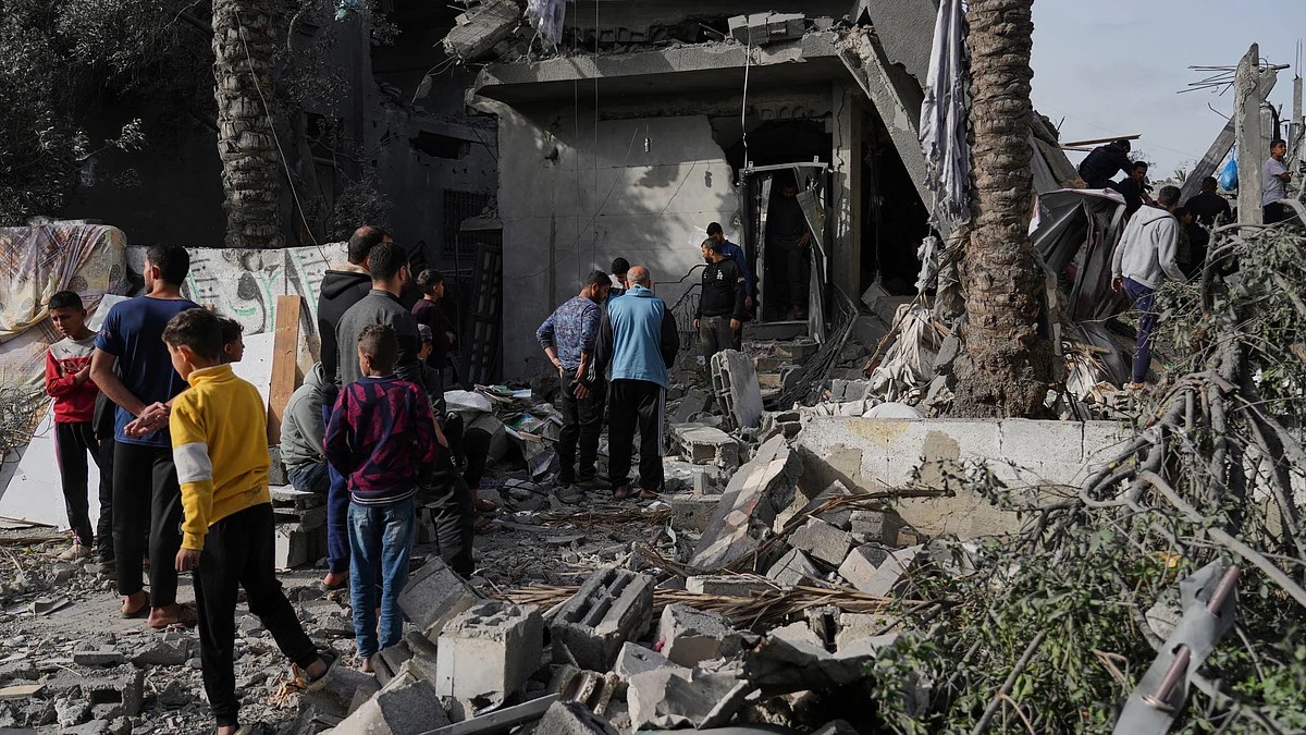 Palestinians inspect a site after Israeli strike in Gaza Strip on 7 April (photo: AP/PTI)