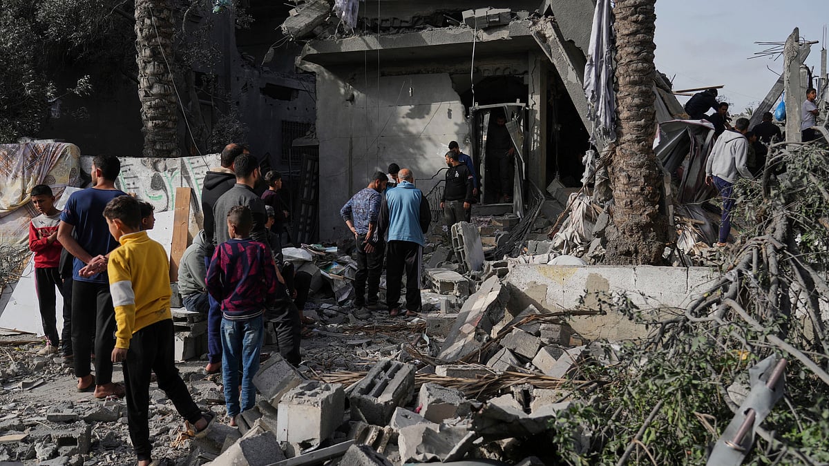 Palestinians inspect a site after Israeli strike in Gaza Strip on 7 April (photo: AP/PTI)