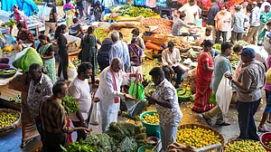 People purchase vegetables from a wholesale market in Bengaluru on 29 March (photo: PTI)