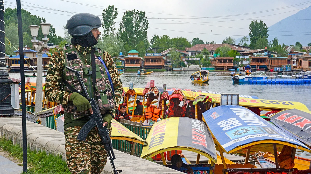 A security official keeps vigil on the banks of the Dal Lake in Srinagar