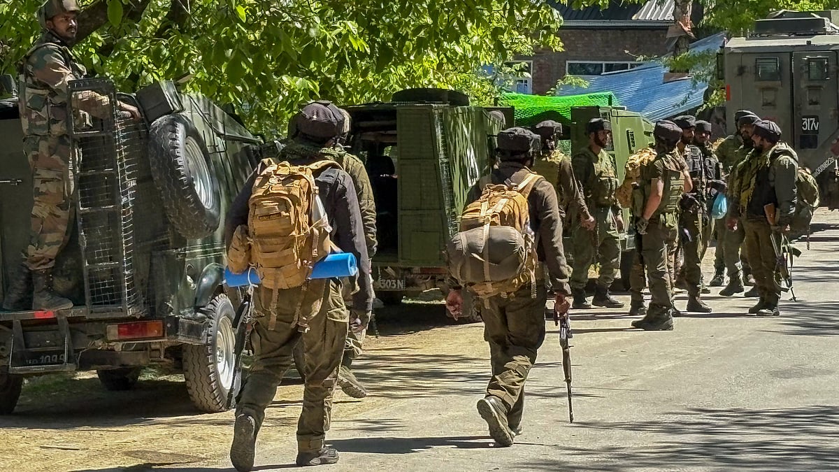 Security personnel conduct a search operation in Anantnag on 29 April (photo: PTI)