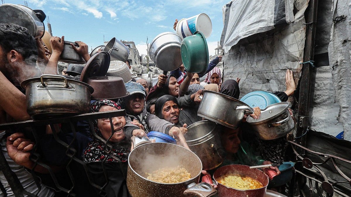 Hungry Palestinians in Gaza block, offload dozens of UN food trucks