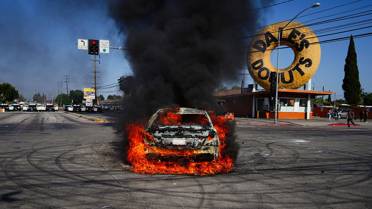 FBI director warns Los Angeles protesters against hitting cops