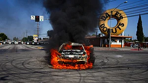 FBI director warns Los Angeles protesters against hitting cops