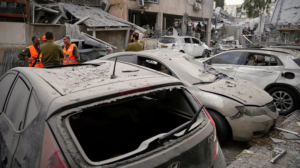 Damaged cars at the site of an Iranian missile strike in Bnei Brak near Tel Aviv, 16 June (photo: AP/PTI)
