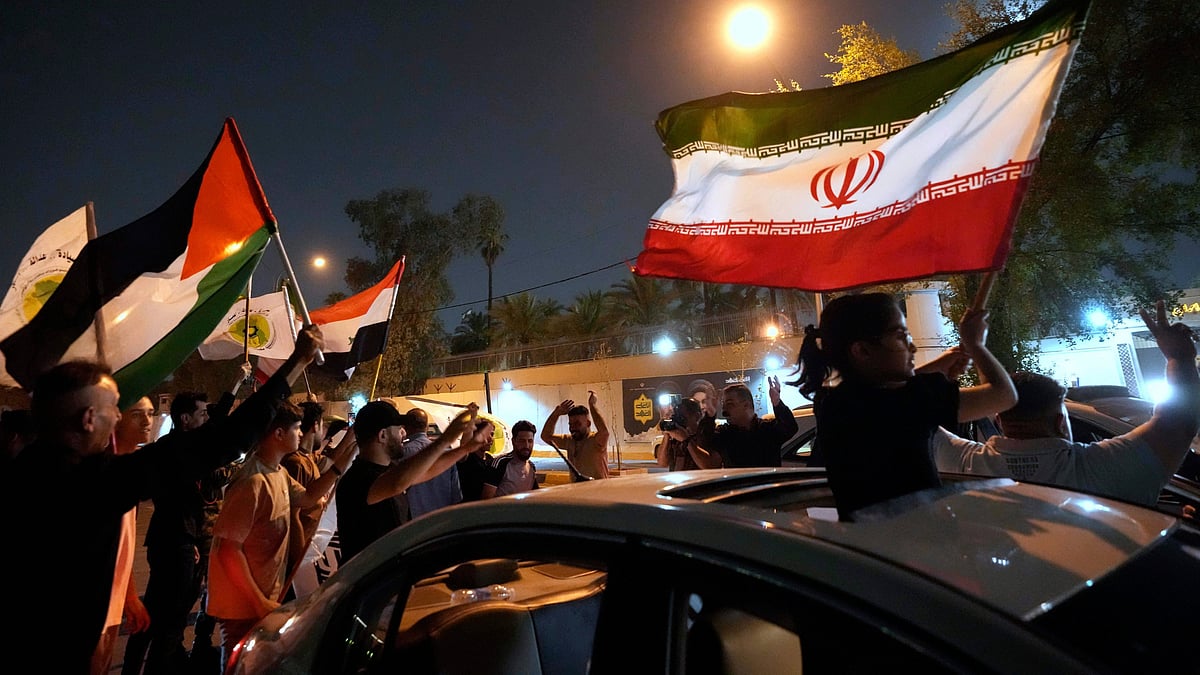 Protesters celebrate after ceasefire between Iran and Israel in Baghdad on 24 June (photo: AP/PTI)