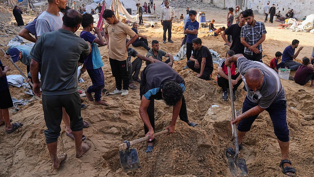 Palestinians look for belongings in Gaza City on 28 June (photo: AP/PTI)