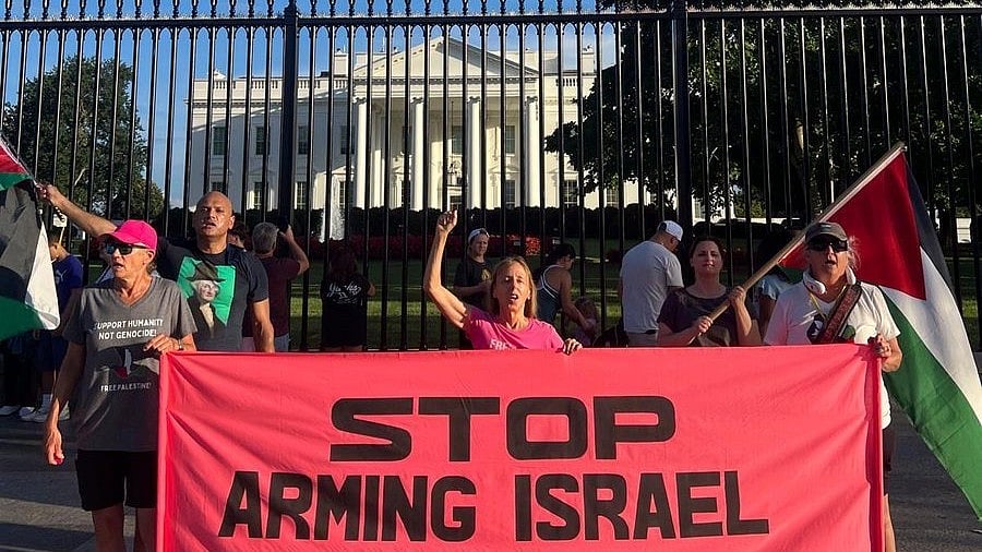 CODEPINK protestors hold a banner saying 'Stop Arming Israel' outside the White House