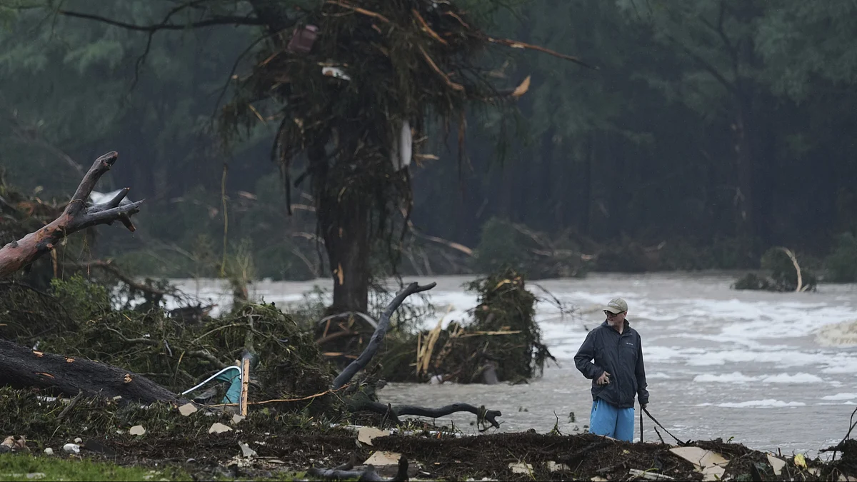 A man surveys debris along the Guadalupe River on 4 July (photo: AP/PTI)
