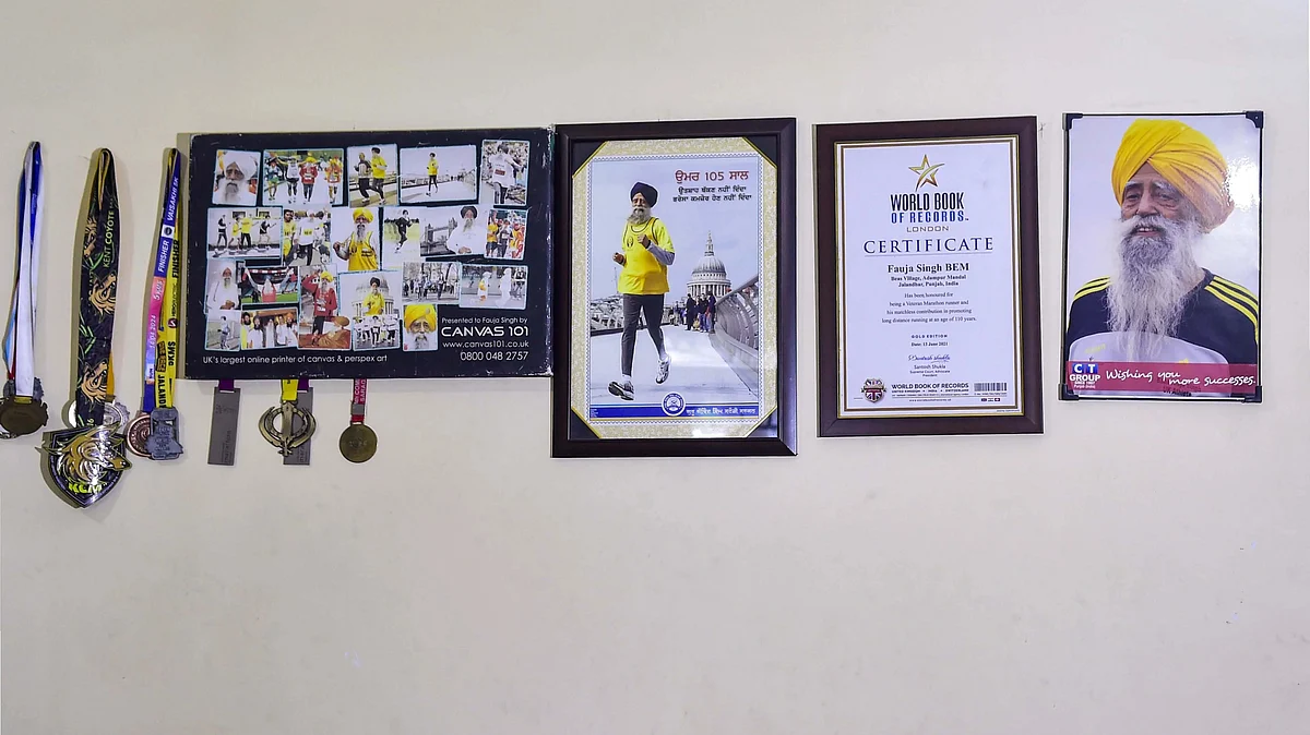 Medals and certificates adorn the wall of Fauja Singh's home in Jalandhar. (photo: PTI)