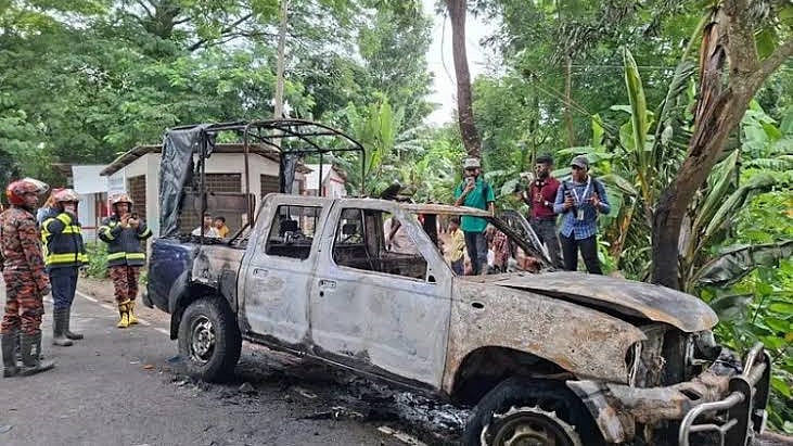 A police vehicle torched by a mob in Gopalganj