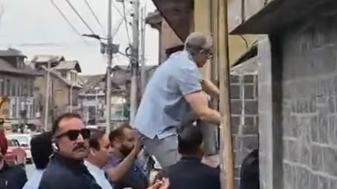 J&K chief minister Omar Abdullah scales a wall to enter the Mazar-e-Shuhada in Srinagar, 14 July 2025