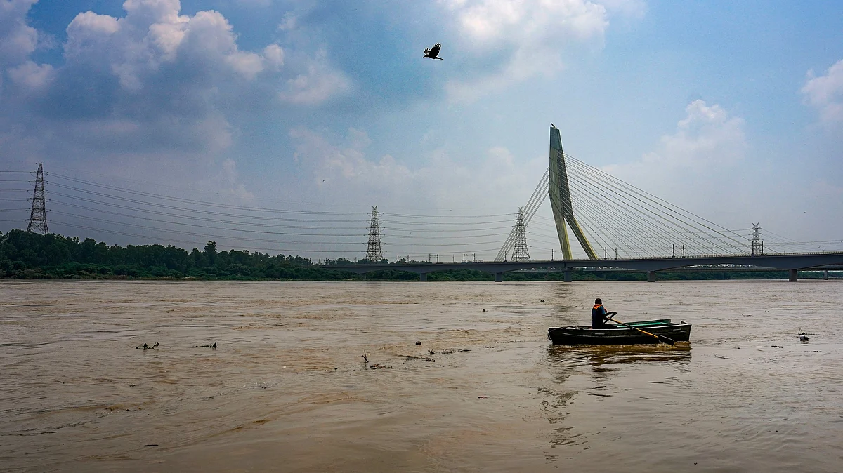Man rows across the flooded Yamuna at Wazirabad