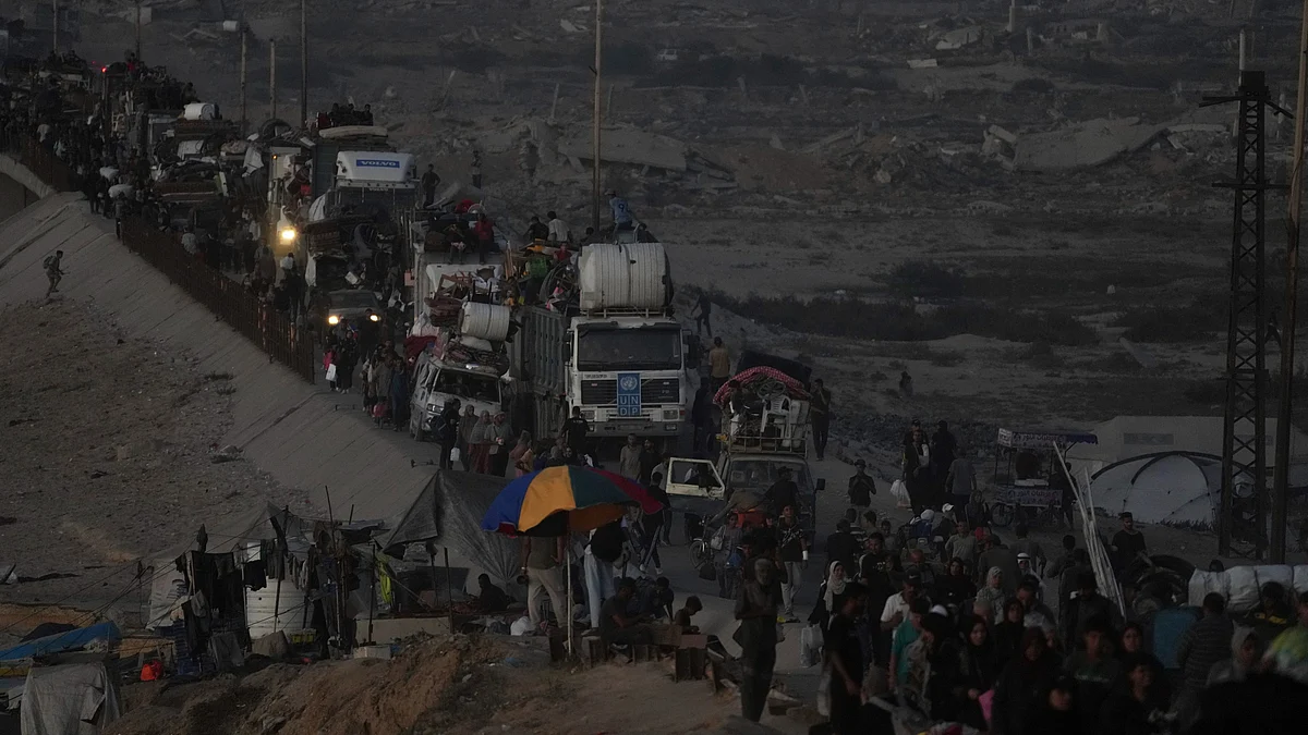 Displaced Palestinians flee Gaza City with belongings on 19 September