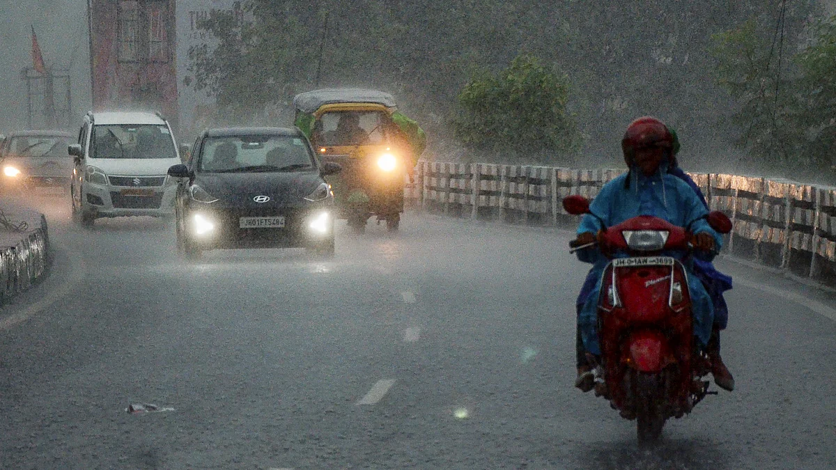 Commuters navigate rain-soaked streets in Ranchi.