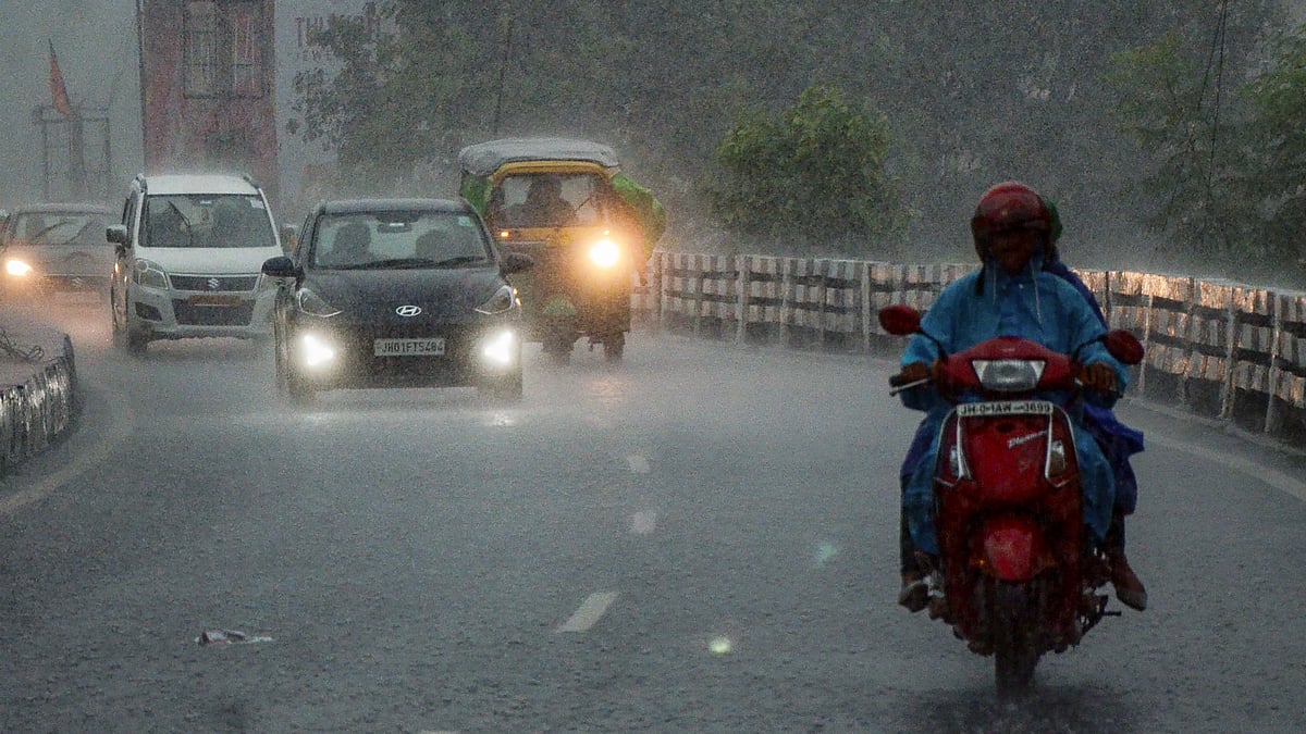 Commuters navigate rain-soaked streets in Ranchi.