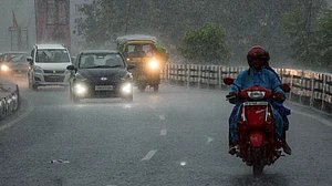 Commuters navigate rain-soaked streets in Ranchi.