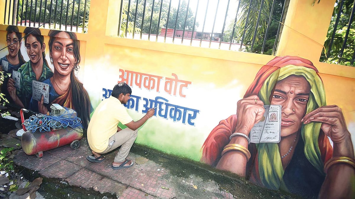 An artist paints election murals in Patna