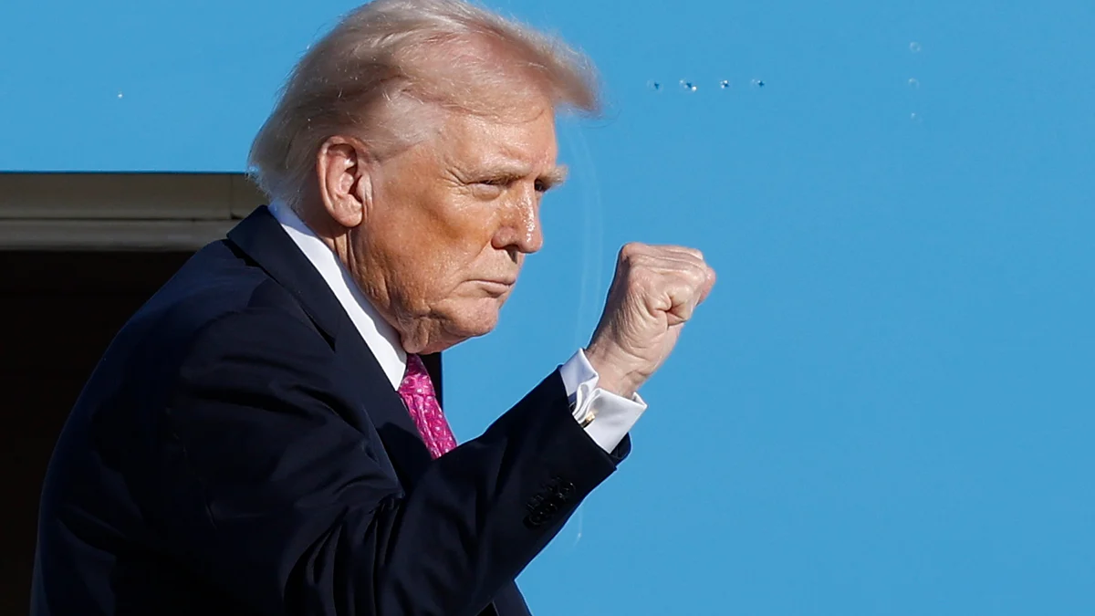Donald Trump gestures from stairs of Air Force One at Joint Base Andrews, Md.