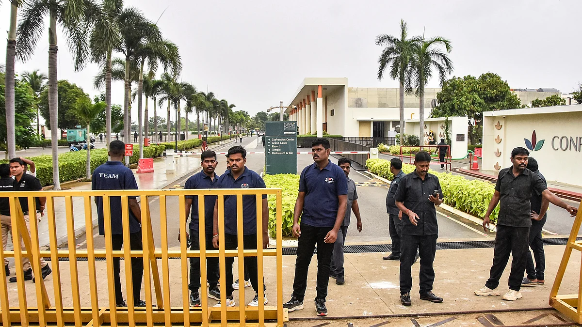 Security personnel stand guard outside a resort where actor-politician Vijay is meeting families.