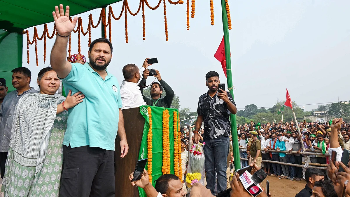 RJD leader Tejashwi Yadav greets supporters during an election rally in Maner, Patna.