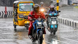 Vehicles make their way through rain-soaked streets as showers lash parts of Tamil Nadu.