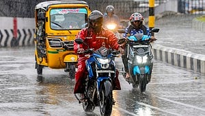 Vehicles make their way through rain-soaked streets as showers lash parts of Tamil Nadu.