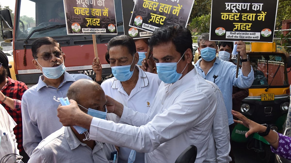 DPCC chief Devender Yadav distributes masks amid rising pollution at ITO.
