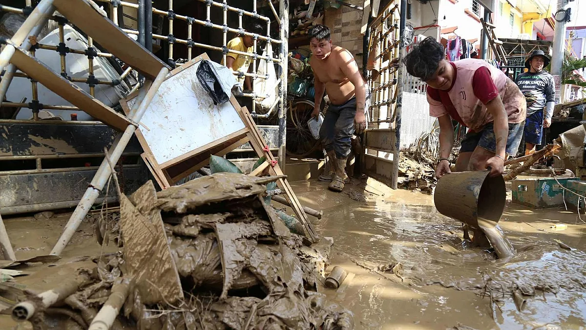 Residents clear debris after Typhoon Kalmaegi hit Talisay City in Cebu, central Philippines.