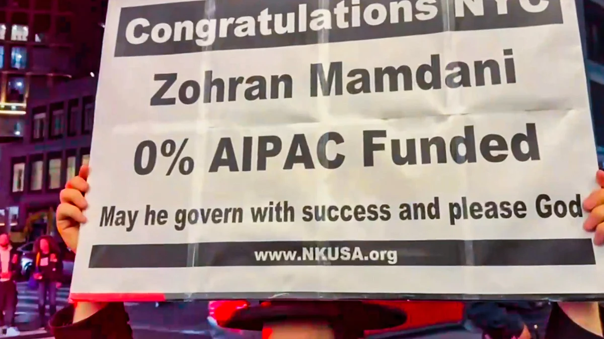 A supporter holds a poster pointing out Zohran Mamdani's lack of corporate funding after his win