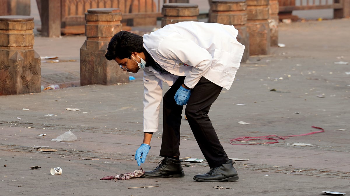 A forensic expert collects evidence from the blast site near Red Fort Metro station