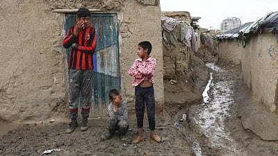 Displaced children navigate life in a makeshift camp.