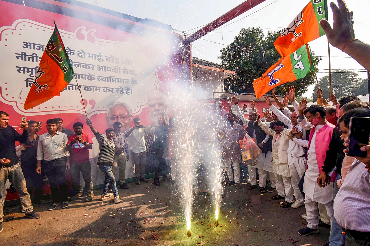 BJP supporters celebrate their alliance's near invincible lead in the Bihar Assembly polls, in Patna (photo: PTI)