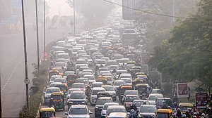 Vehicles crawl through heavy smog at ITO in New Delhi.