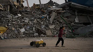 A girl carries bread past rubble from Israeli strikes in Gaza City.