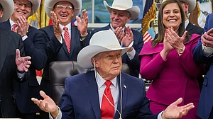 Donald Trump tries on a hat gifted by the 1980 US Olympic hockey team (file photo)