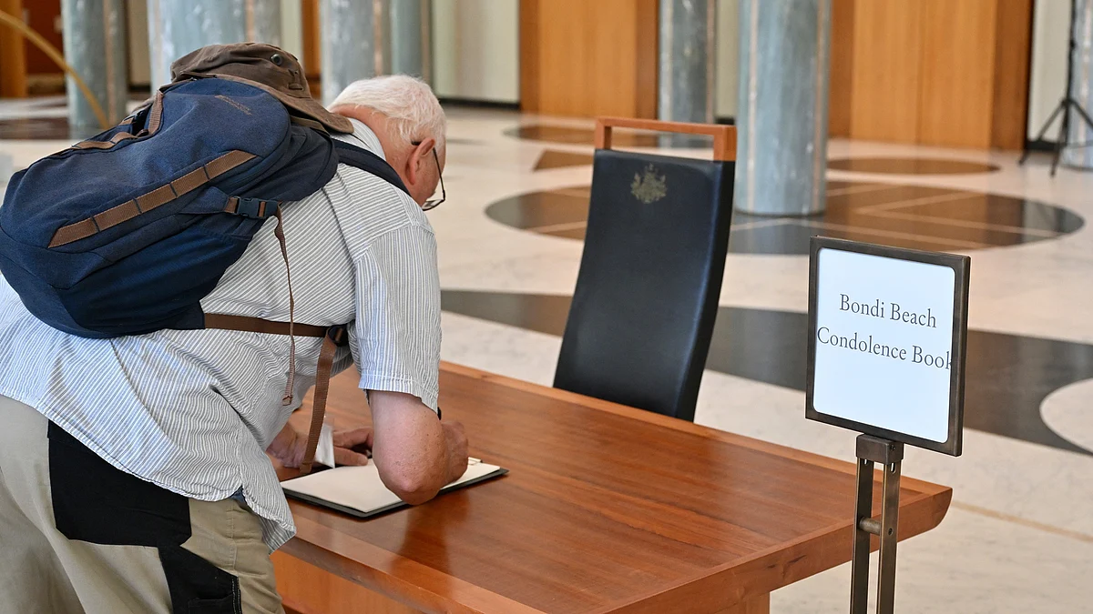 A man writes a condolence message   in Sydney