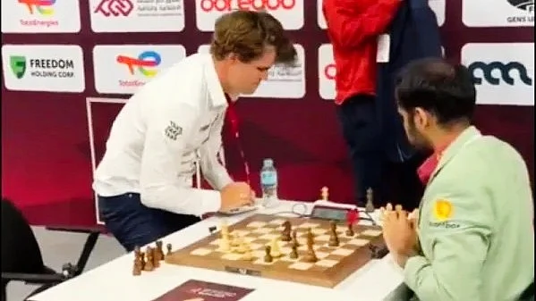 Magnus Carlsen (left) slams the table after losing to Arjun Erigaisi on Monday