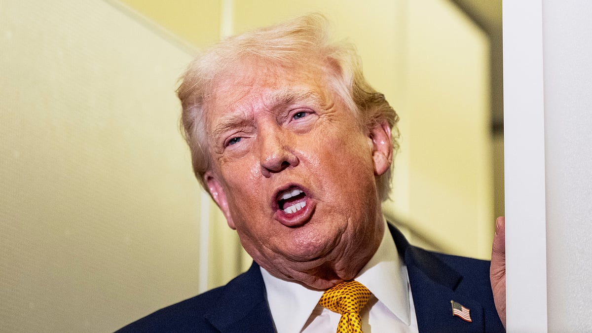 US President Donald Trump speaks to reporters aboard Air Force One.